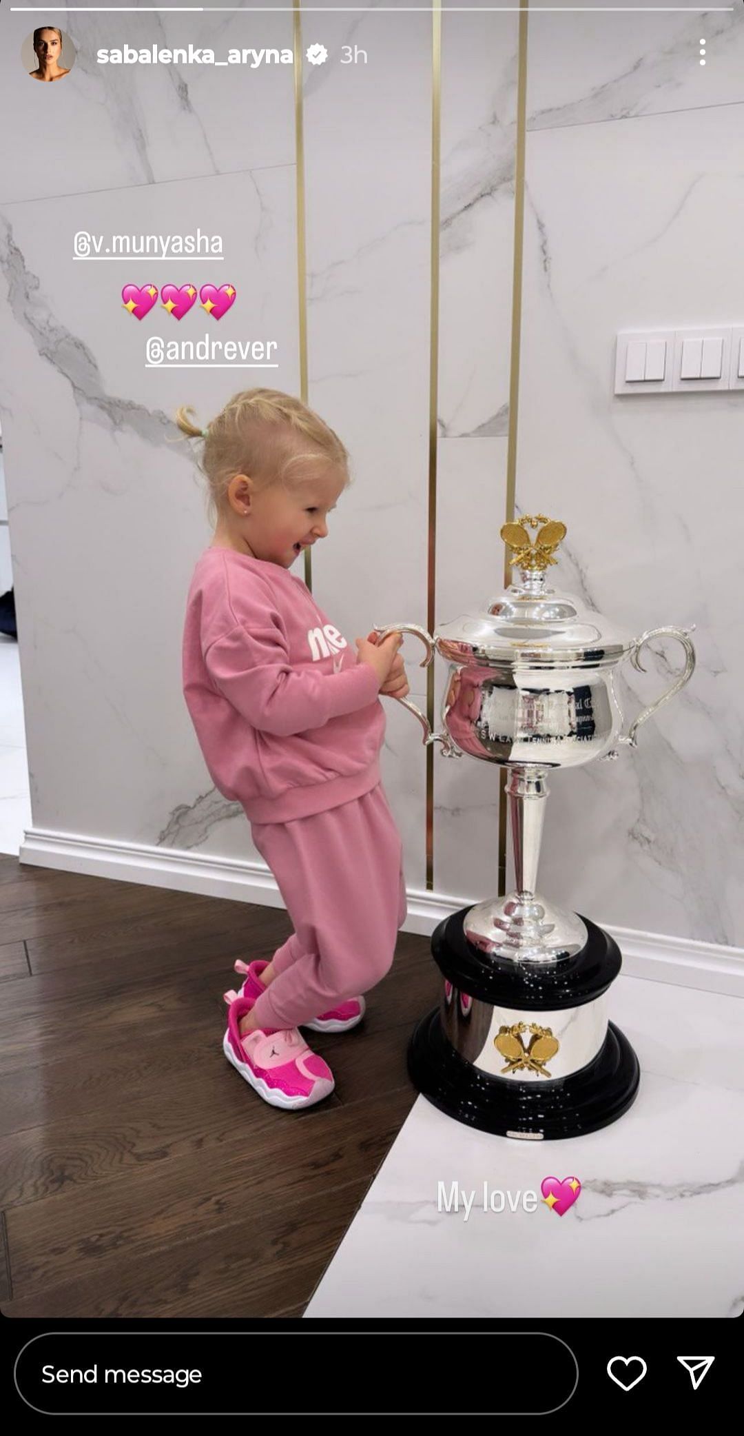 Vasilevski's daughter standing beside Sabalenka's Australian Open trophy