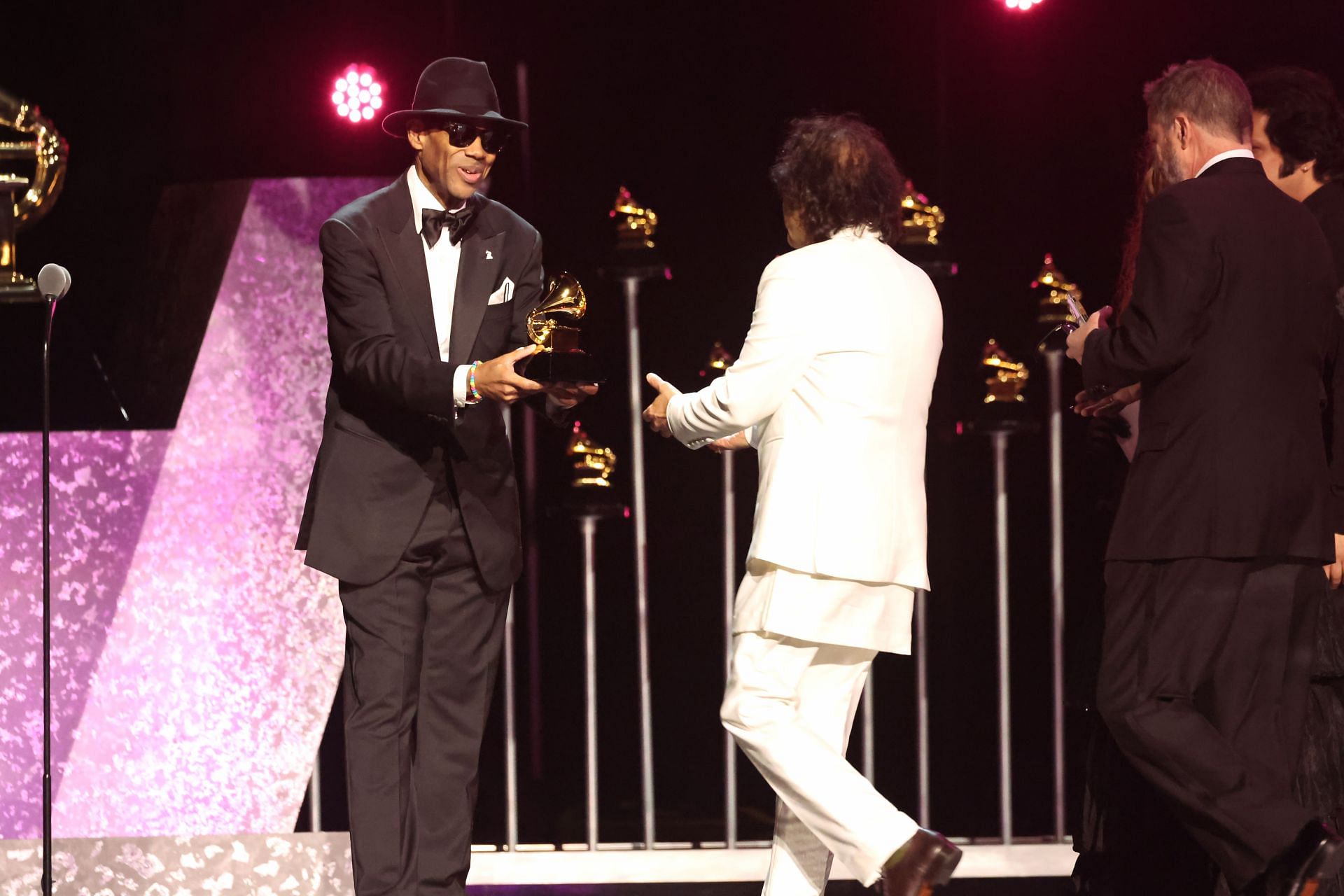 Zakir Hussain, Edgar Meyer, and Rakesh Chaurasia accept the &quot;Global Music Performance&quot; award for &quot;Pashto&quot; onstage from Jimmy Jam during the 66th GRAMMY Awards (Photo by Amy Sussman/Getty Images)