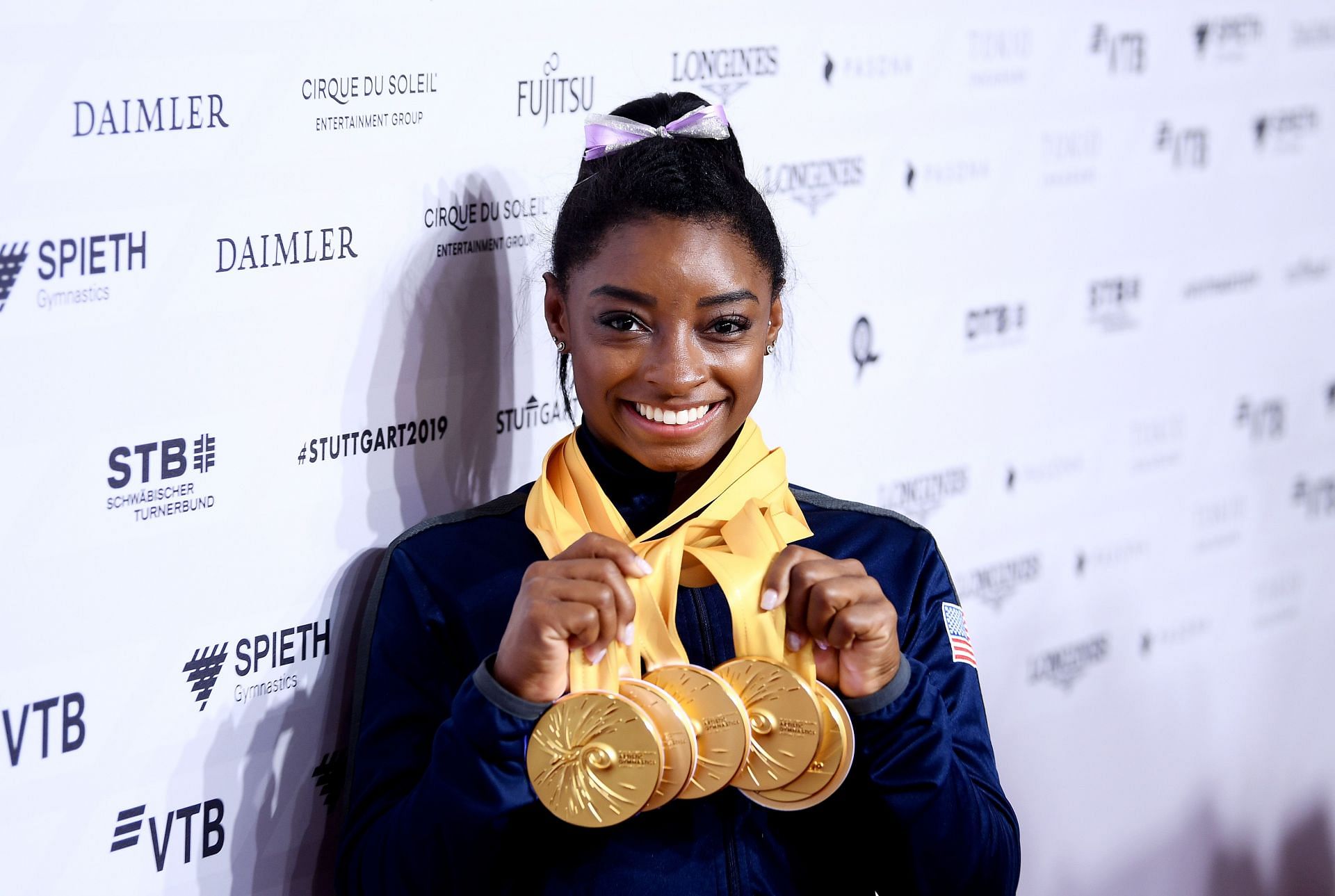 Simone Biles poses with her multiple gold medals during day 10 of the 49th FIG Artistic Gymnastics World Championships 2019 in Stuttgart, Germany. (Photo by Laurence Griffiths/Getty Images)