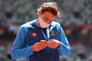 Gold medalist Armand Duplantis looks at his medal during the medal ceremony for the Men's Pole Vault Final at the 2020 Olympic Games in Tokyo, Japan.