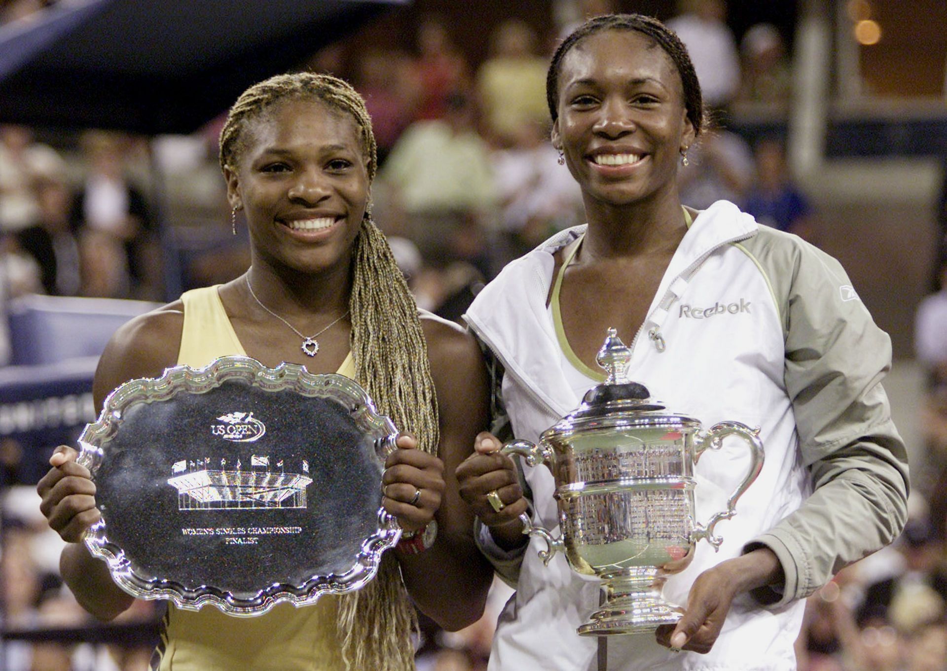 Serena and Venus Williams pictured with their trophies at the 2001 US Open