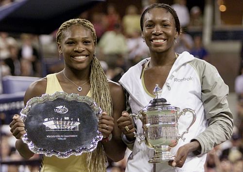 Serena and Venus Williams pictured with their trophies at the 2001 US Open