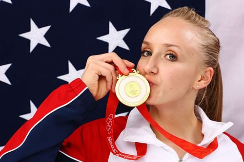 Liukin poses with her gold medal after winning the Women's all around Gymnastics event in the NBC Today Show Studio. (Photo by Kristian Dowling/Getty Images)