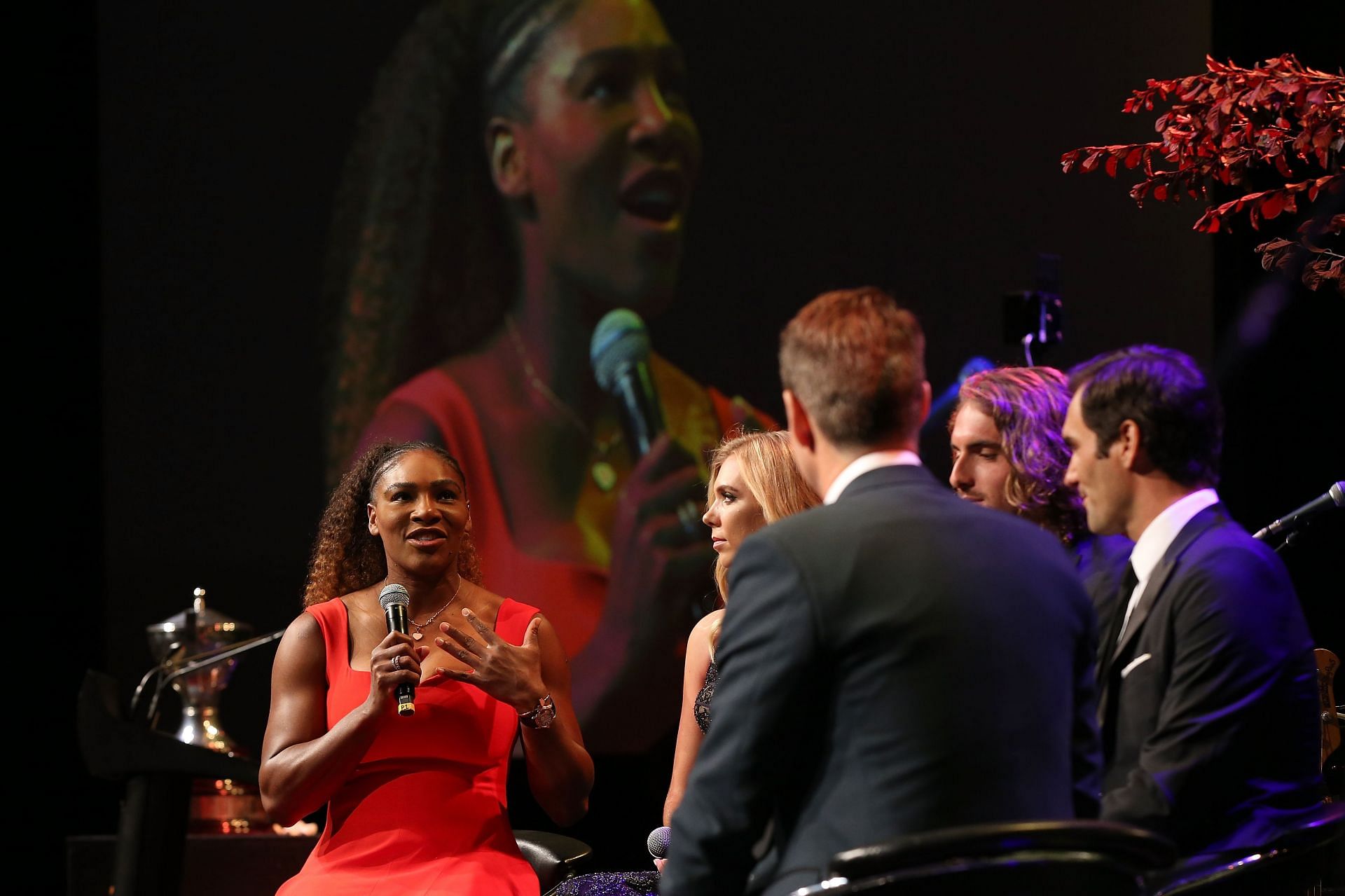 Tennis players interact during a conference in 2018