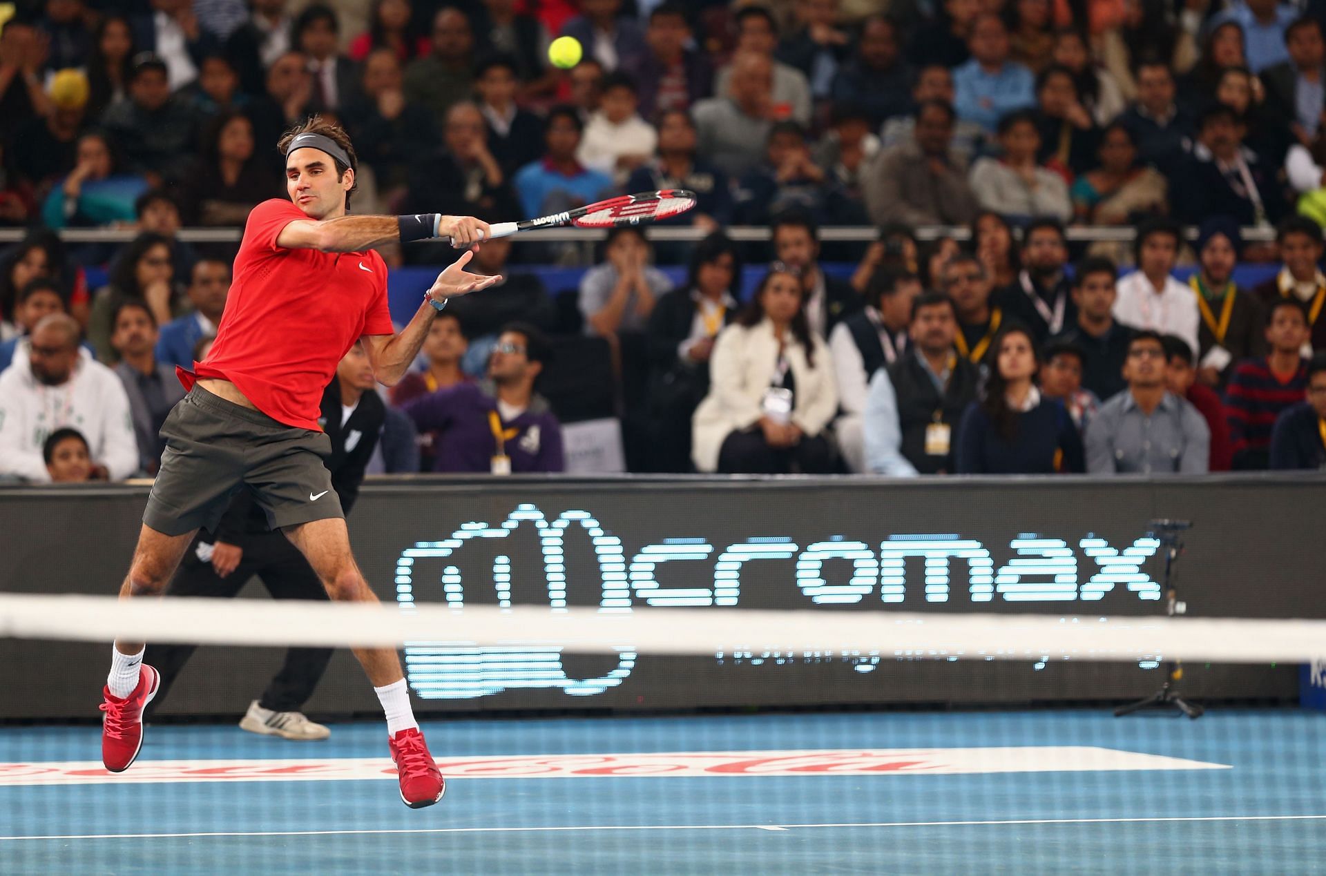 Roger Federer of the Indian Aces plays a forehand against Novak Djokovic of the UAE Royals during the Coca-Cola International Premier Tennis League third leg at the Indira Gandhi Indoor Stadium December 8, 2014 in Delhi, Delhi - Getty Images