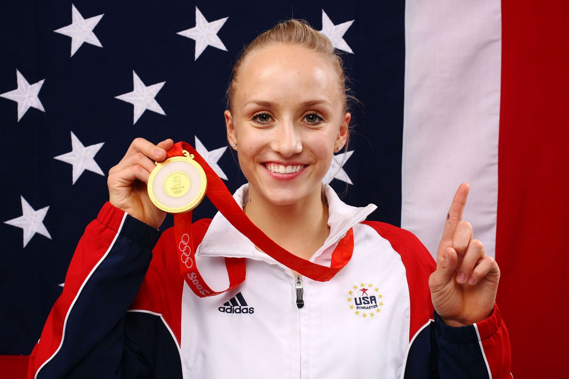 Liukin poses with her gold medal after winning the Women&#039;s all around Gymnastics event at the Beijing 2008 Olympic Games. (Photo by Kristian Dowling/Getty Images)