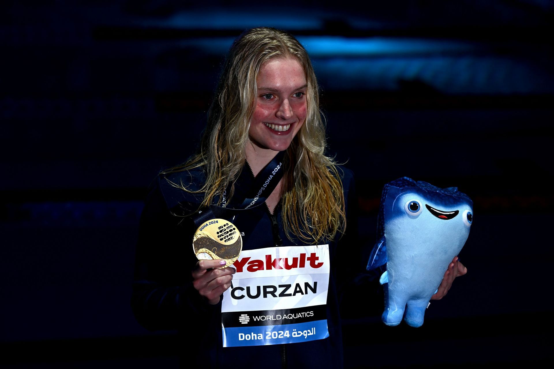 Claire Curzan poses with her gold medal after the Medal Ceremony for the Women&#039;s 50m Backstroke Final at the 2024 World Aquatics Championships at Aspire Dome in Doha, Qatar.
