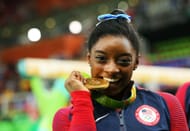 Gold medalist Simone Biles poses for photographs after the medal ceremony for the Women's Individual All-Around at the 2016 Rio Olympics in Brazil.