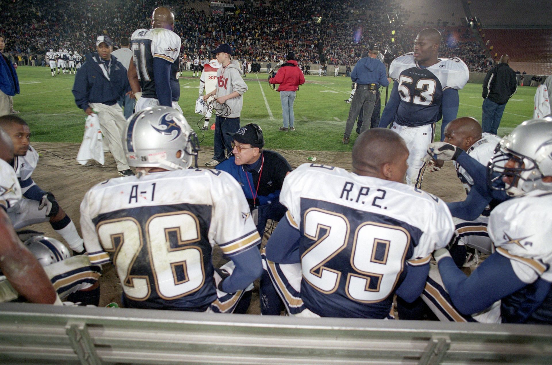 Head Coach Al Luginbill of the Los Angeles Xtreme discusses strategy with Dell &quot;A-1&quot; McGee #26 and Ricky &quot;R.P. 2&quot; Parker #29