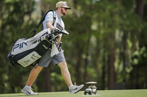 Joe LaCava Jr. carrying a golf bag