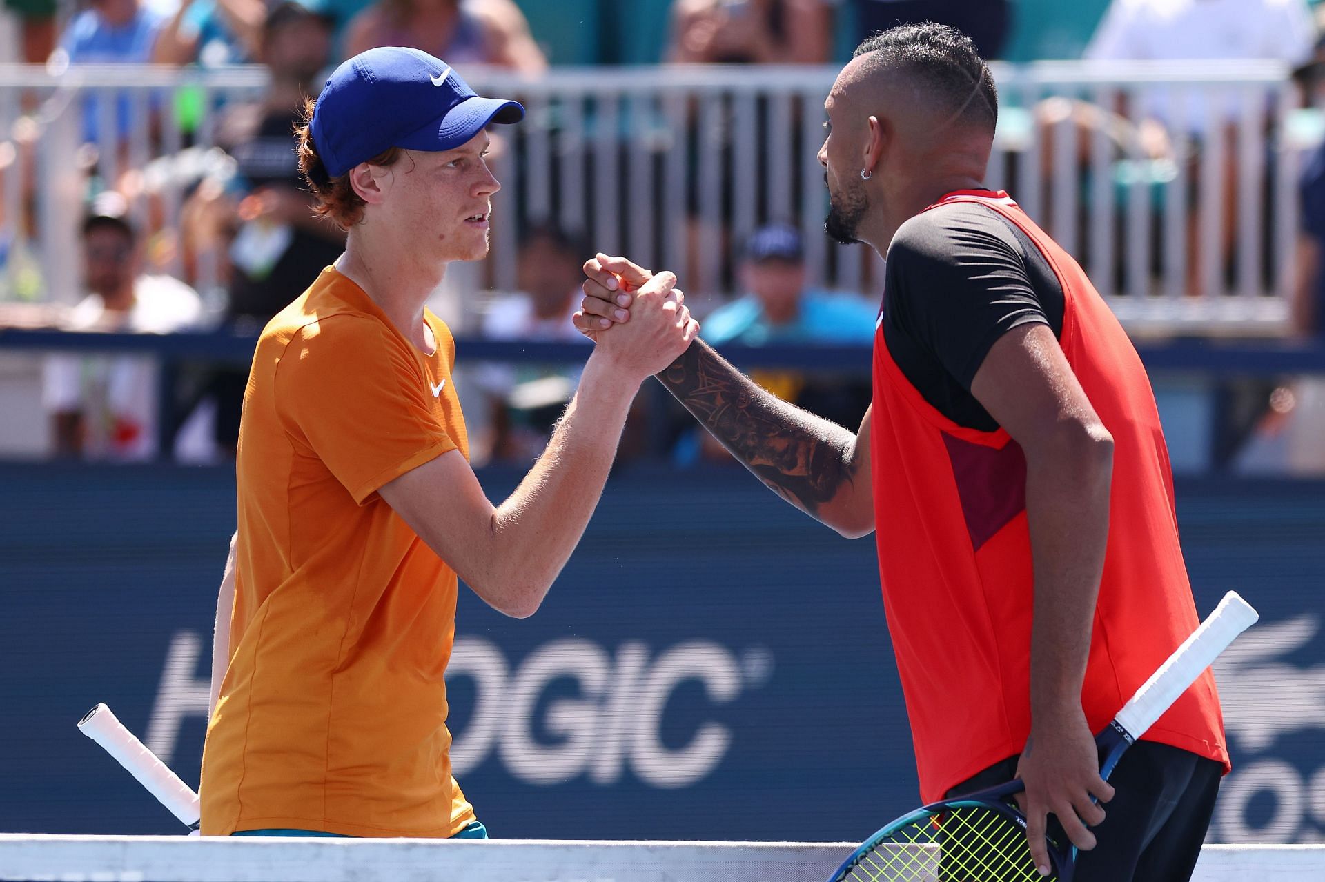 Nick Kyrgios and Jannik Sinner interact after a match in 2022