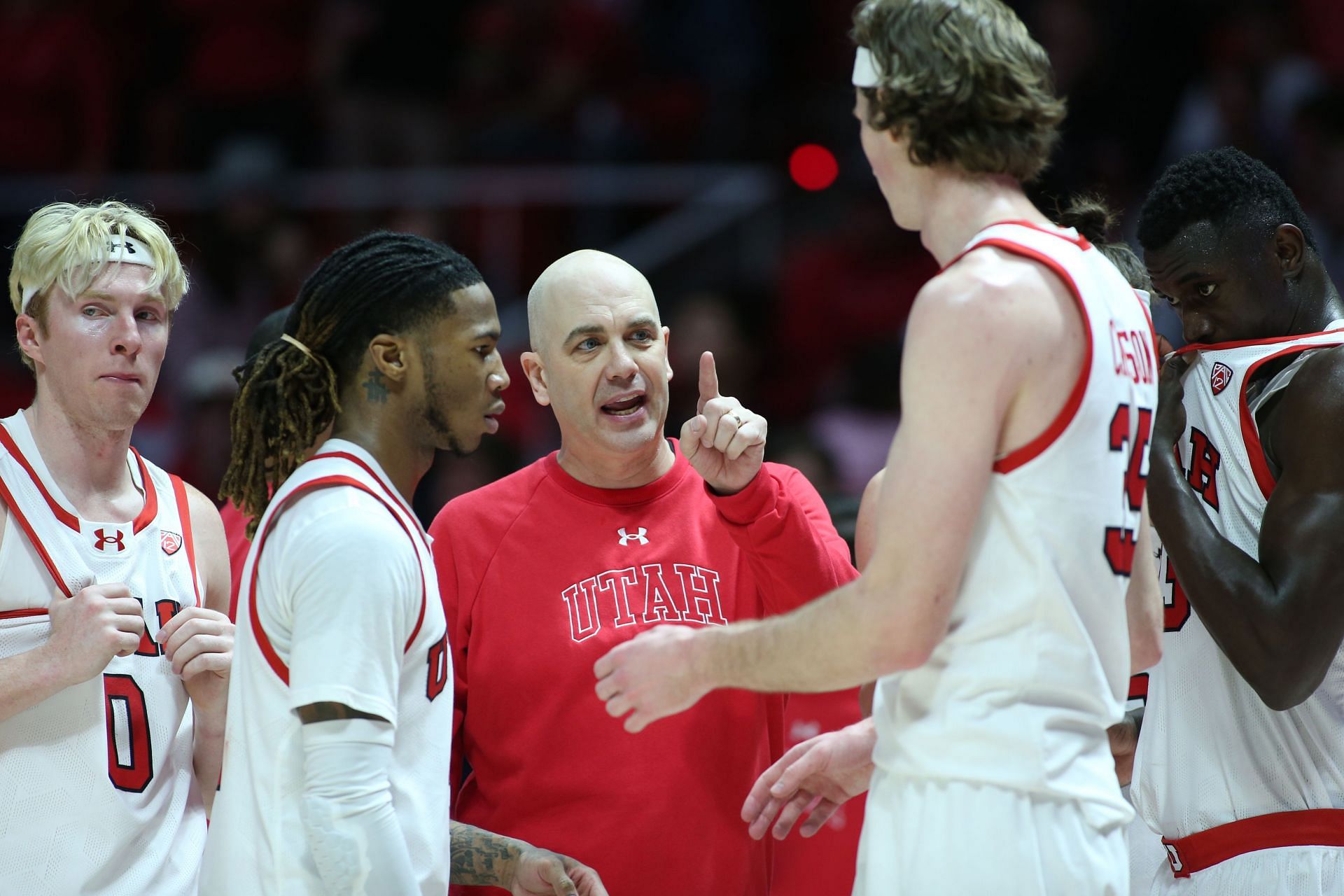 Utah head coach Craig Smith talks to his players during a timeout.