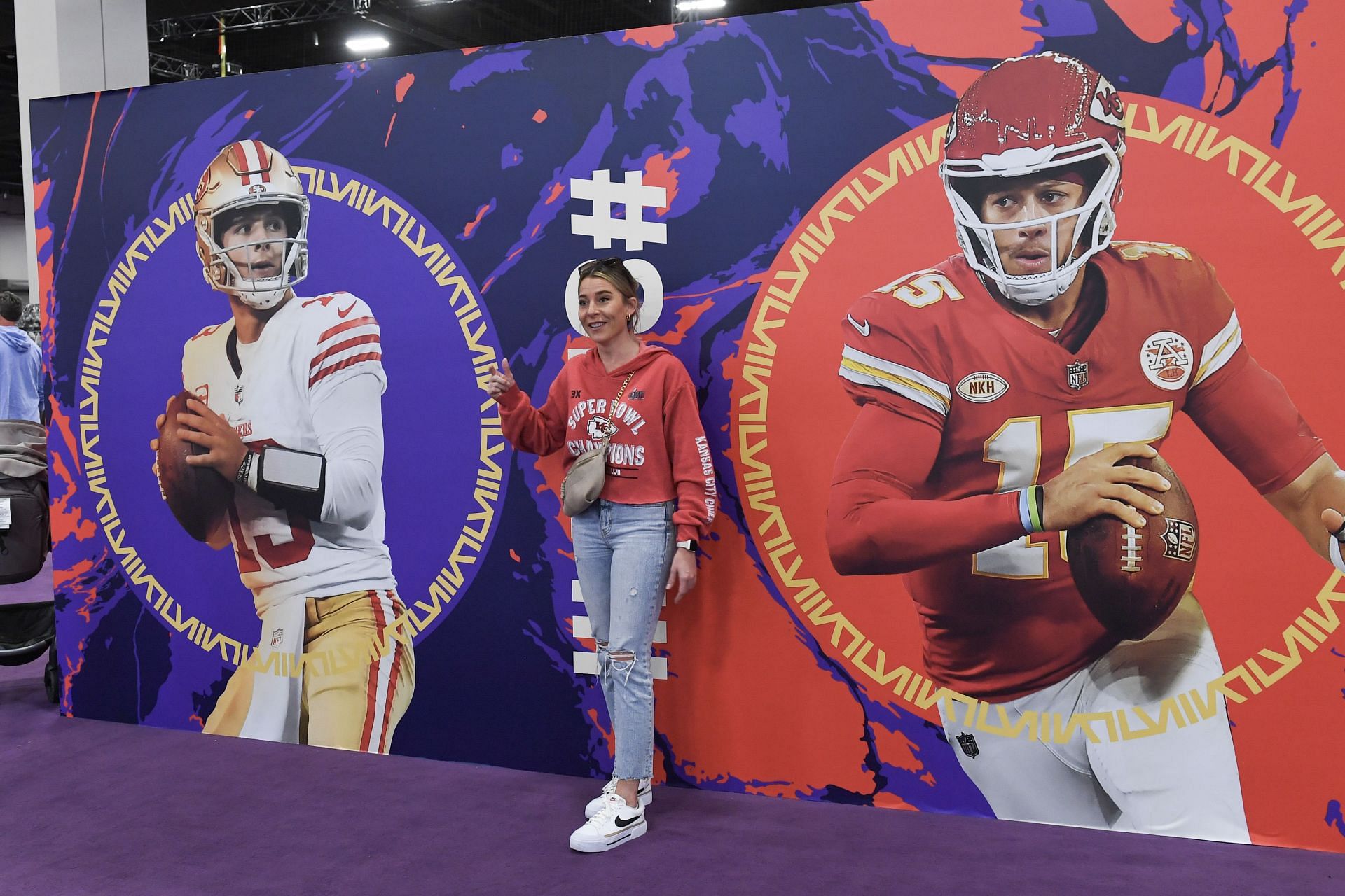 Fan stands in front of Mahomes-Purdy display at NFL experience in Las Vegas