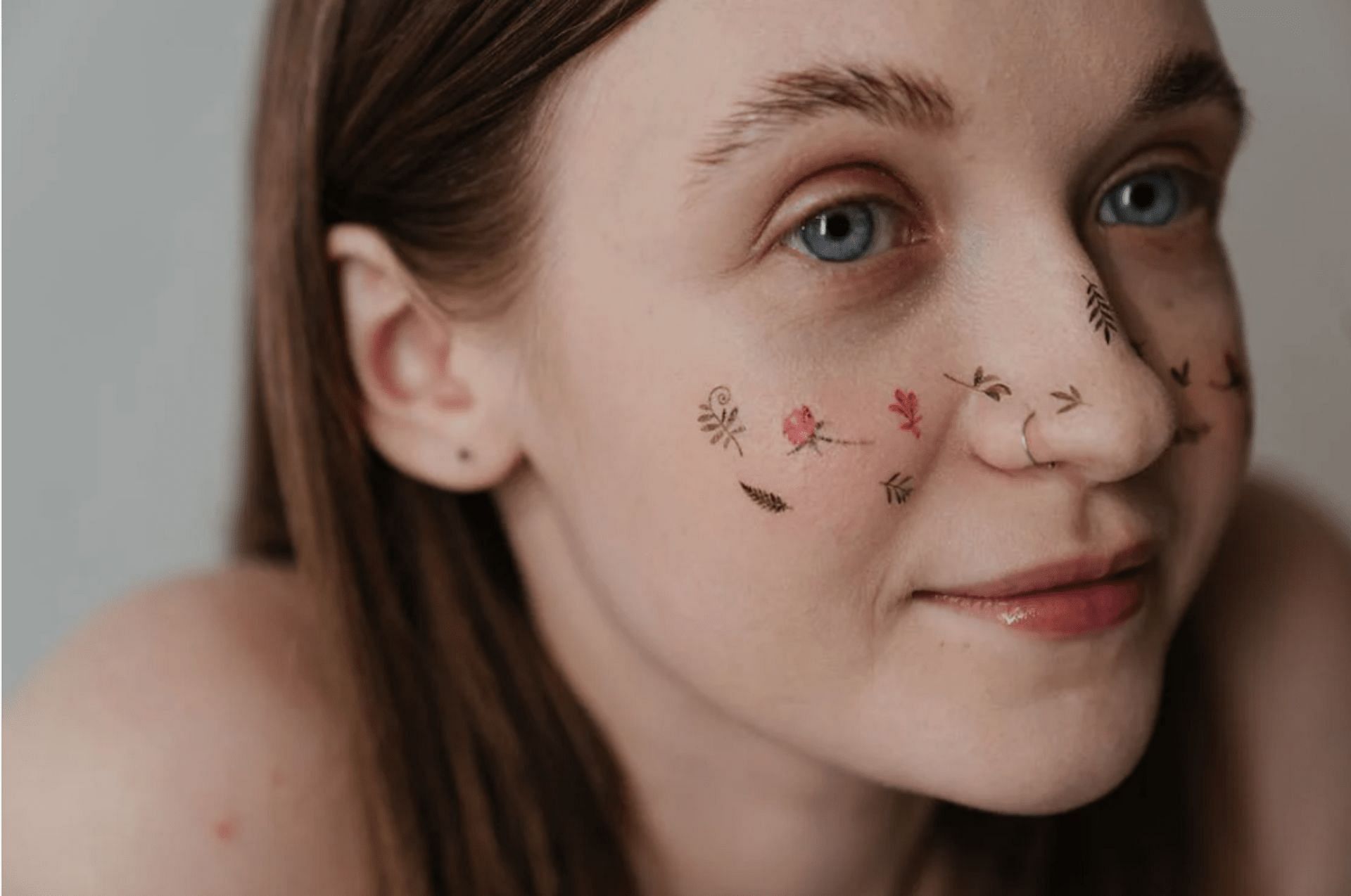 Temporary face tattoos (Image via Pexels/cottonbro studio)