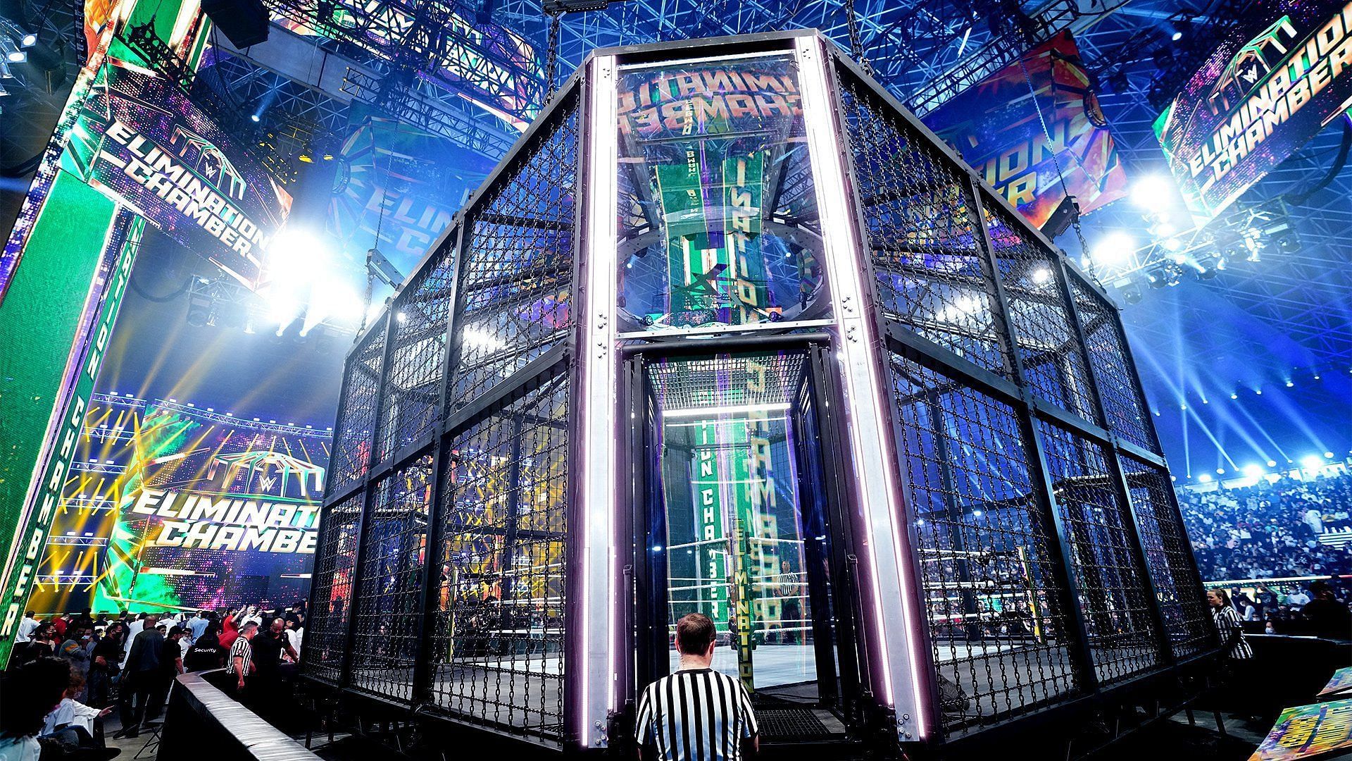 A WWE referee checks on the side door to the Elimination Chamber structure