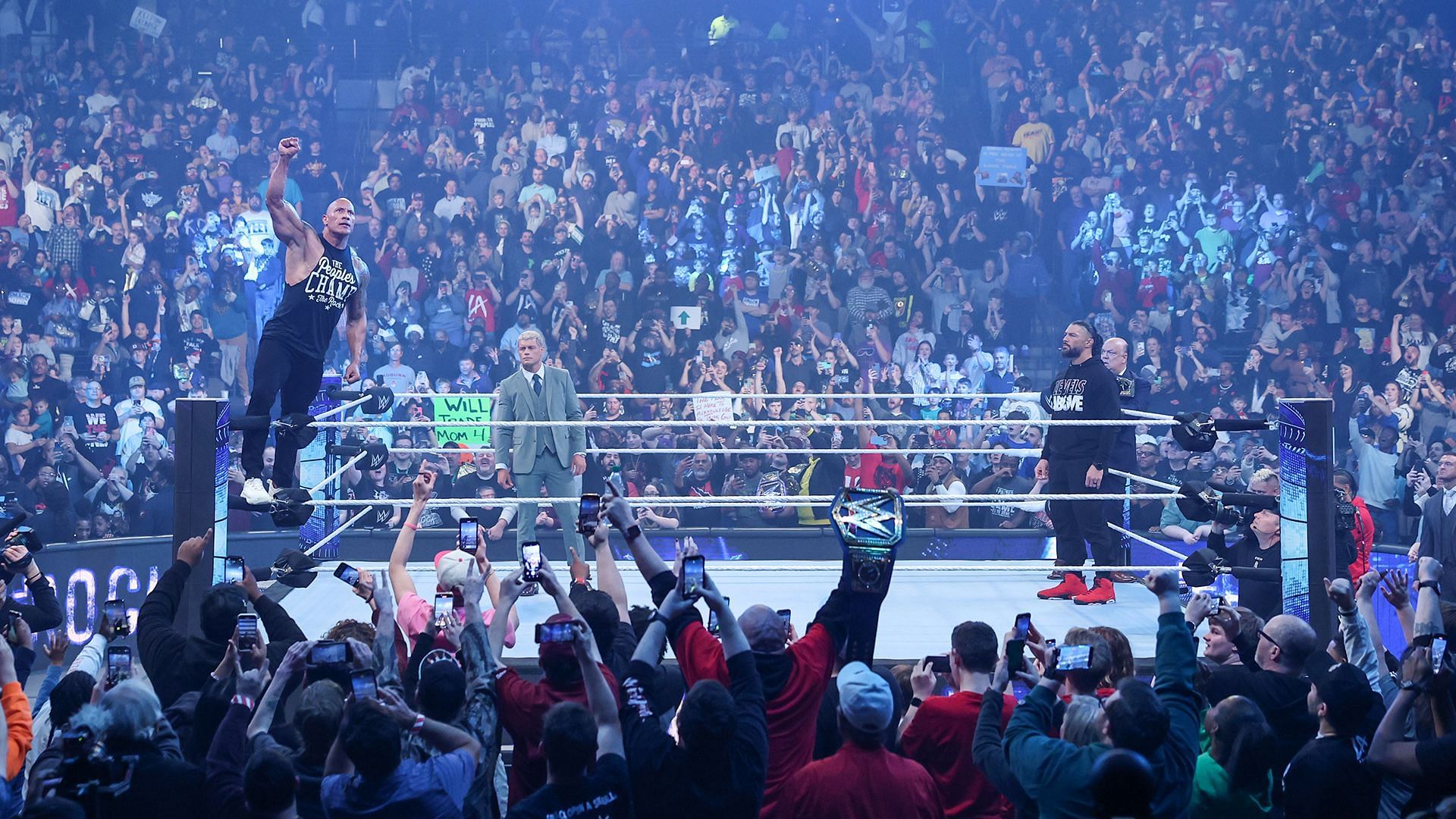 The Rock poses on WWE SmackDown while Cody Rhodes, Roman Reigns and Paul Heyman look on