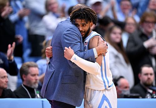 Head coach Hubert Davis embraces RJ Davis #4 of the North Carolina Tar Heels during the second half of the game against the Wake Forest Demon Deacons at the Dean E. Smith Center.