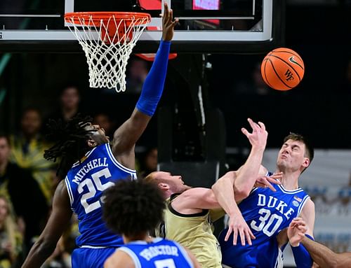 Kyle Filipowski (30) tries to block a shot.