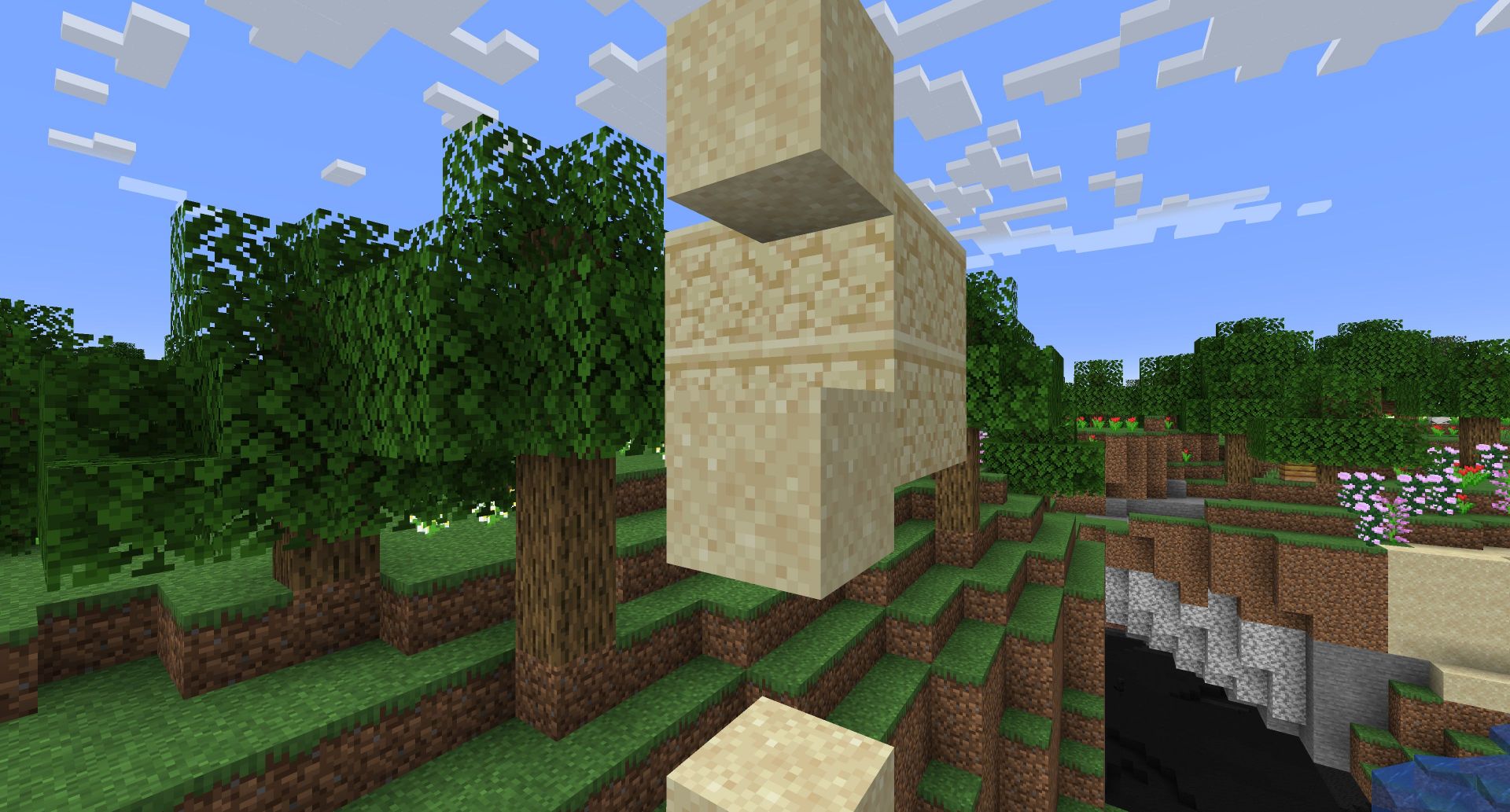 Falling sand next to floating sandstone (Image via Mojang)