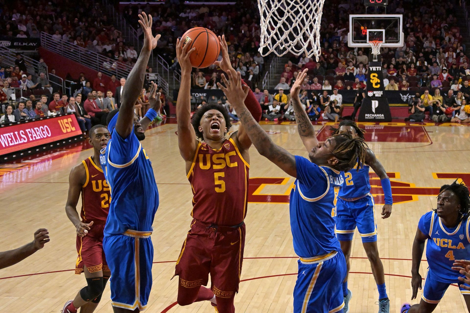 Boogie Ellis attempts a shot against two UCLA defenders.