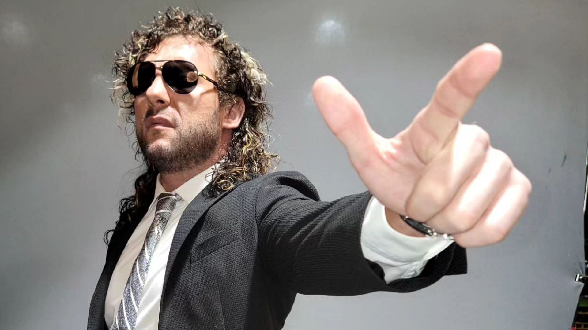 Kenny Omega poses for photo shoot backstage at AEW Dynamite