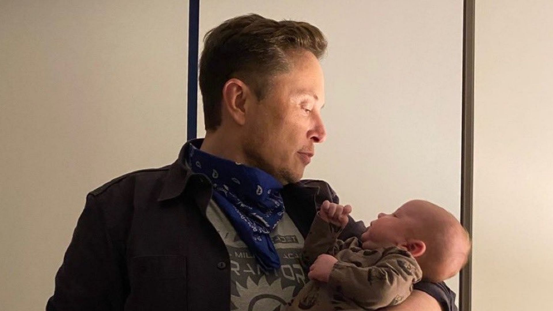 Elon Musk poses for a photo with his son