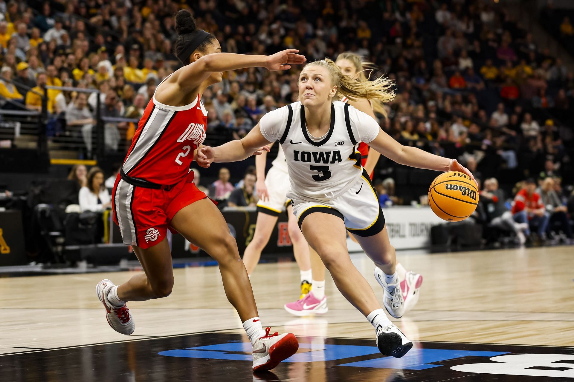 Sydney Affolter #3 of the Iowa Hawkeyes drives to the basket.