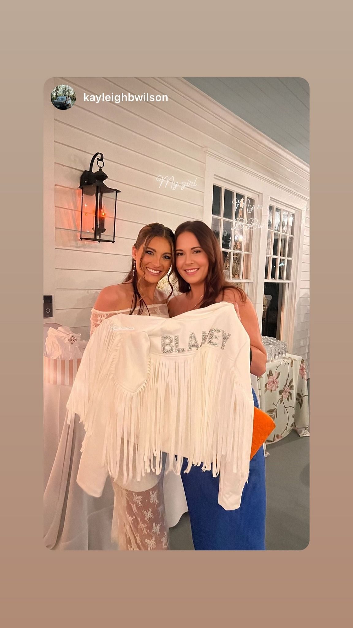 Gianna Tulio and the stylist holding a white jacket having BLANEY written on it. Credits-https://www.instagram.com/giannatulio