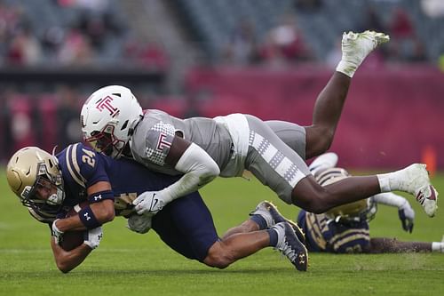 Jordan Magee #6 of the Temple Owls tackles Brandon Chatman #24 of the Navy Midshipmen