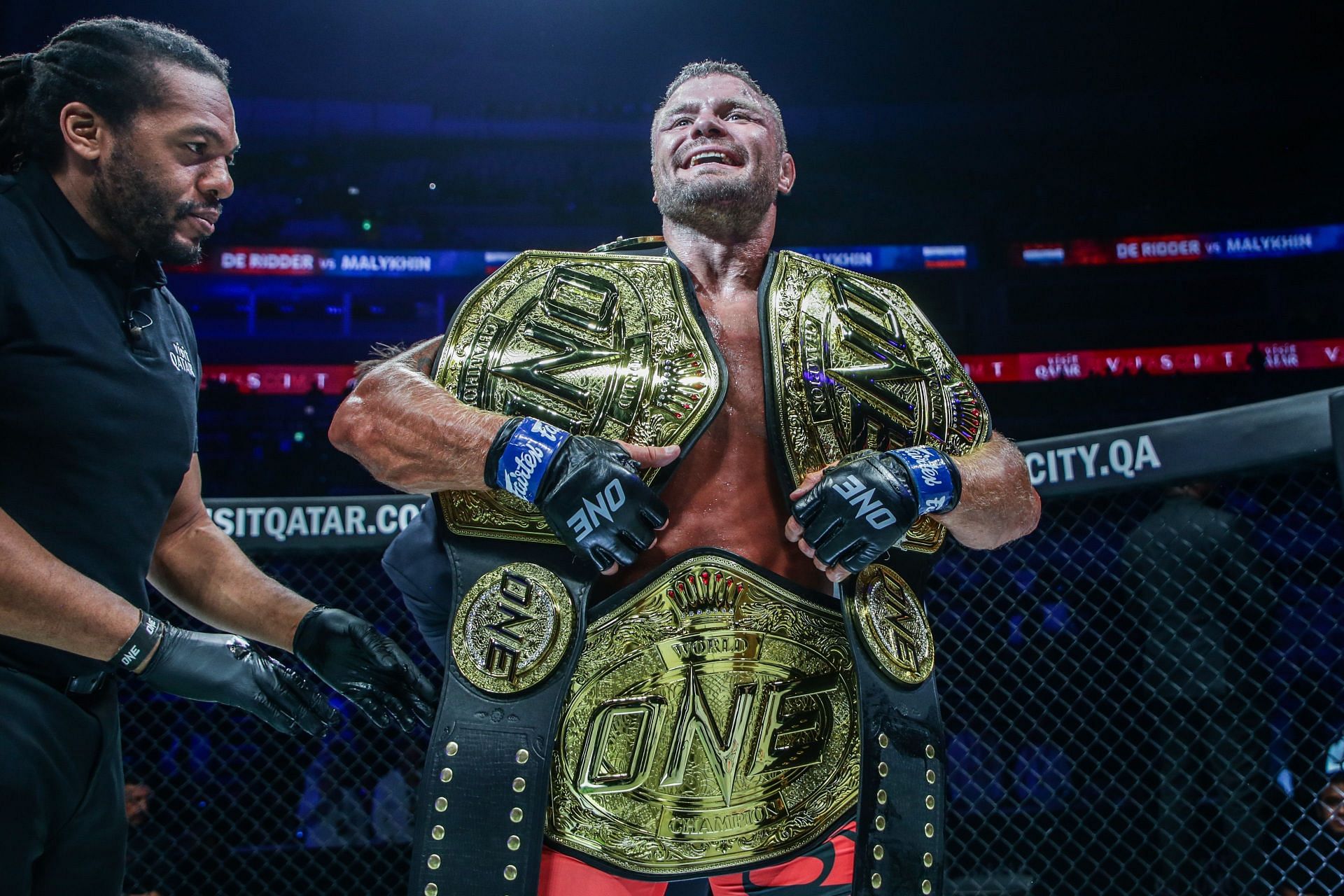 Anatoly Malykhin celebrates with his three ONE Championship world titles in Doha.