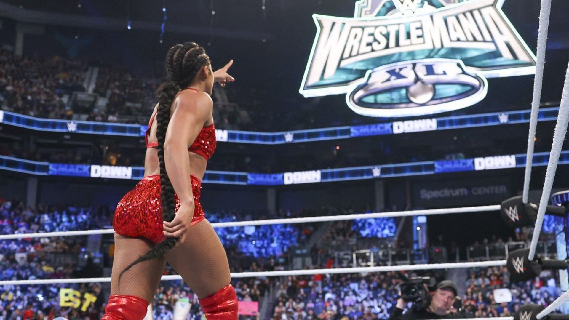 Bianca Belair points to the WrestleMania XL sign on WWE SmackDown