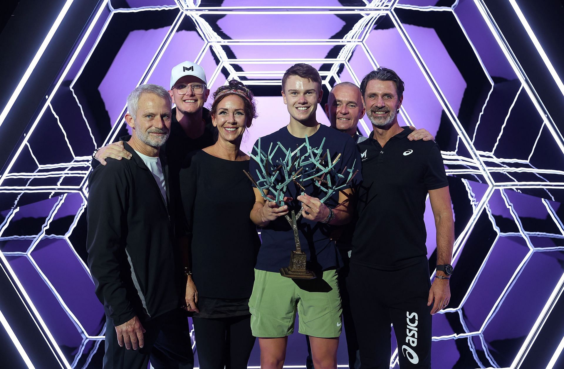 Holger Rune poses with his team after clinching the Paris Masters