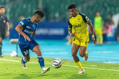 Chennaiyin's Adhikari and Hyderabad FC's Abdul Rabeeh in action on Saturday. [ISL]