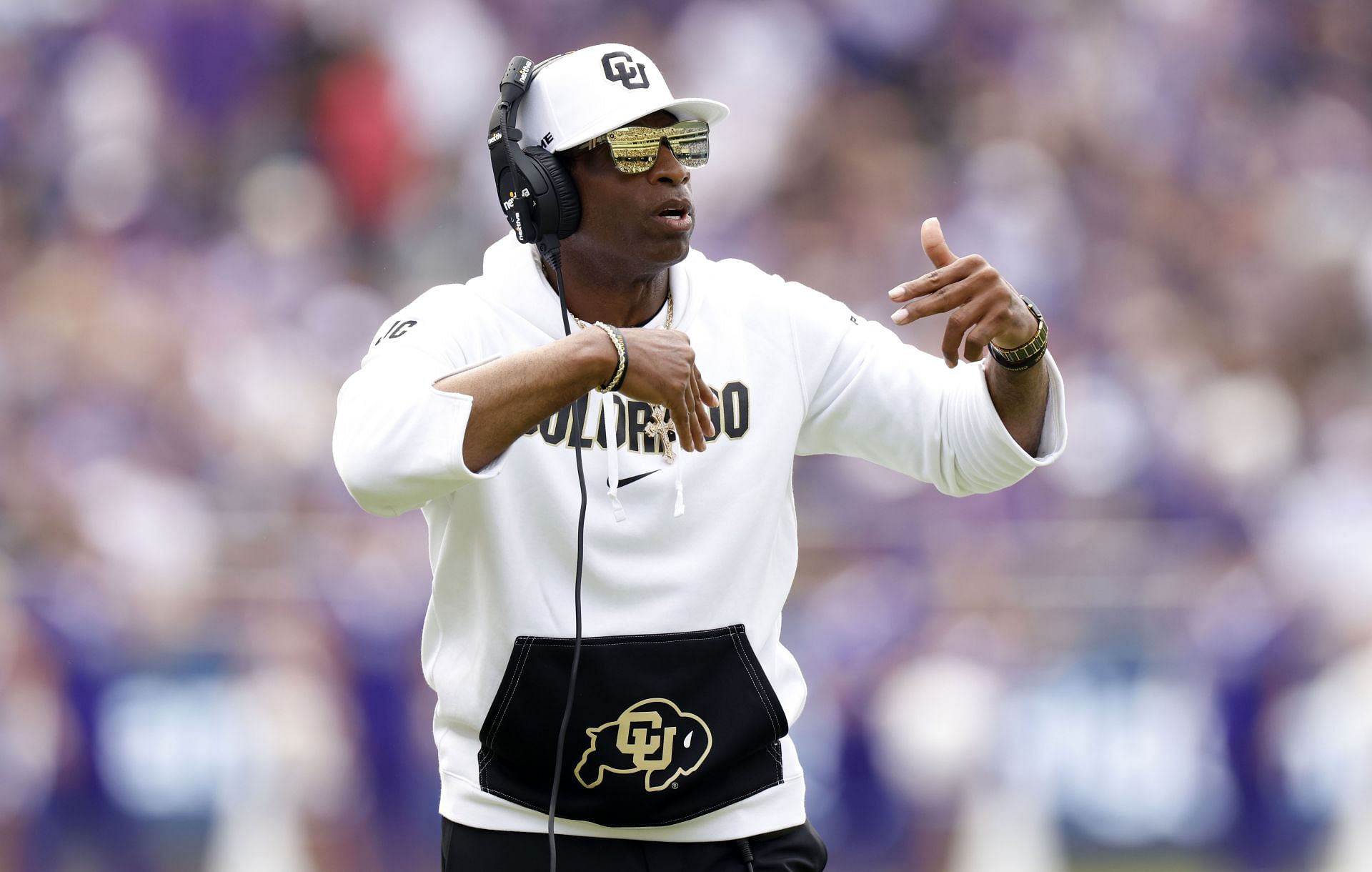 Head coach Deion Sanders of the Colorado Buffaloes calls a play.