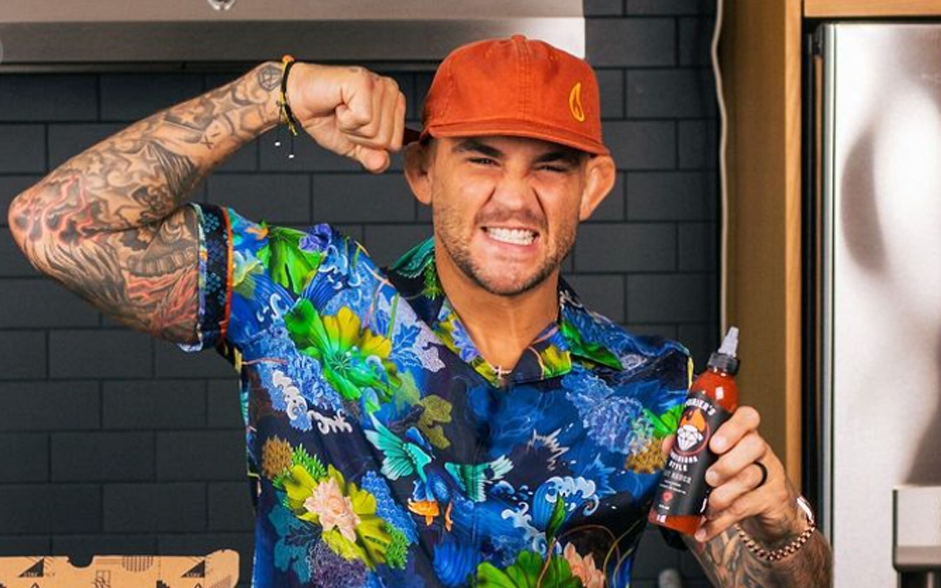 Dustin Poirier posing with the bottle of hot sauce [Image Courtesy: @poiriersauce Instagram]