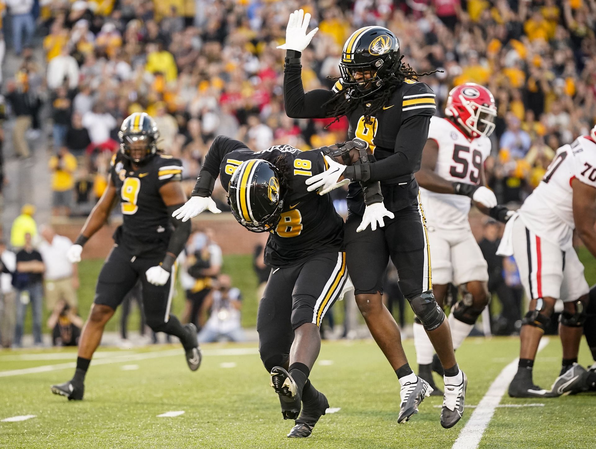 Trajan Jeffcoat #18 of the Missouri Tigers celebrates with Ty'Ron Hopper #8 after a sack against the Georgia Bulldogs