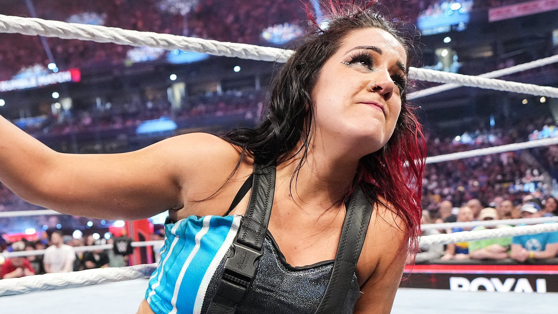 Bayley looks up at the WWE WrestleMania XL sign