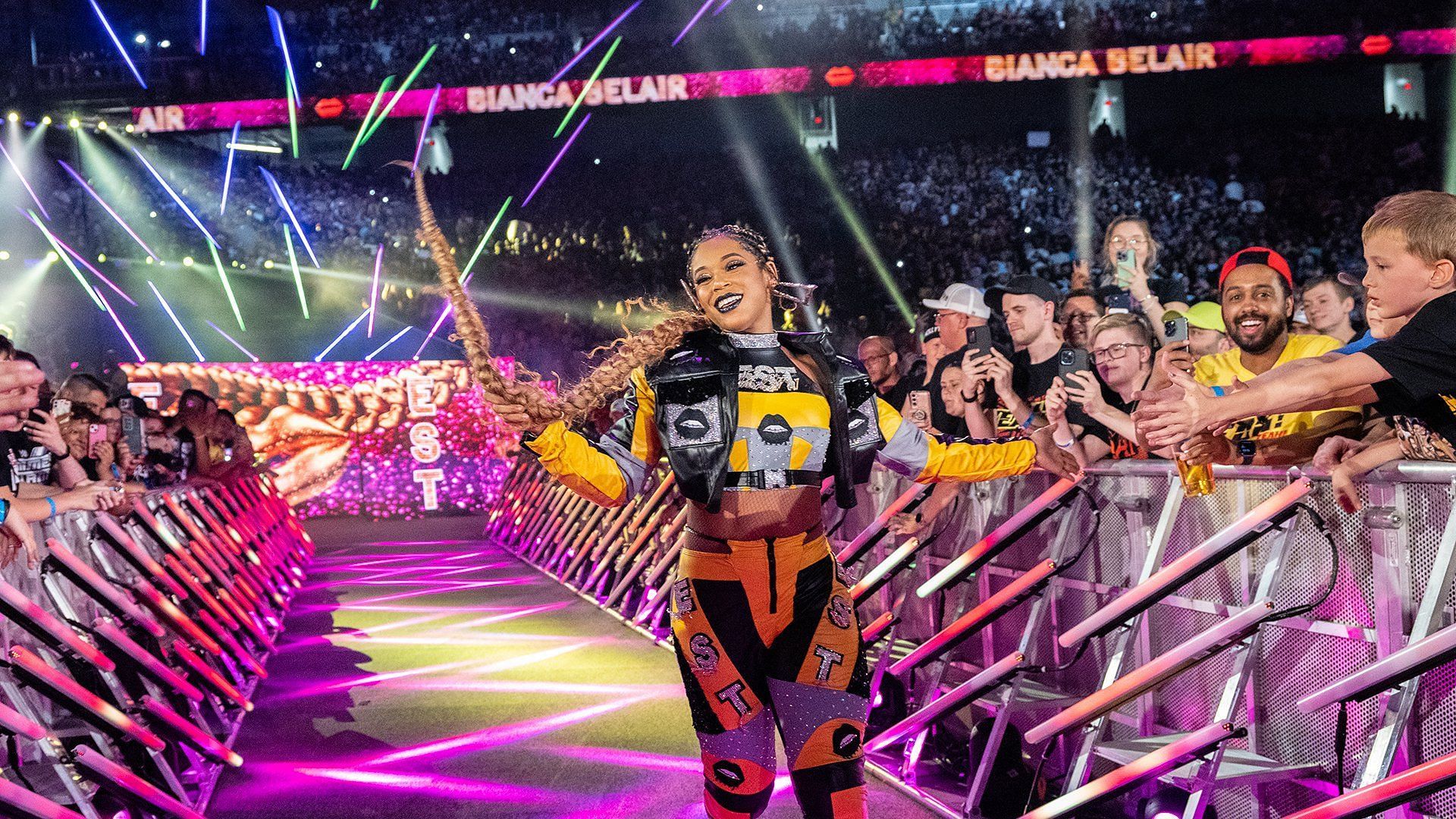 Bianca Belair smiles for the WWE Universe on the way to the ring