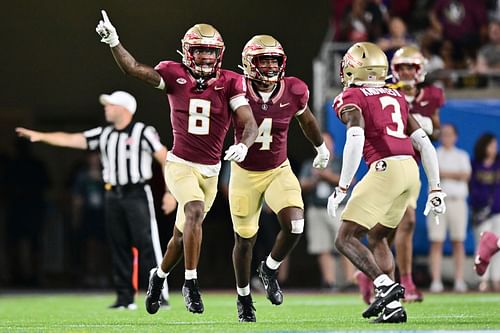 Renardo Green #8 of the Florida State Seminoles reacts after intercepting Jayden Daniels of the LSU Tigers