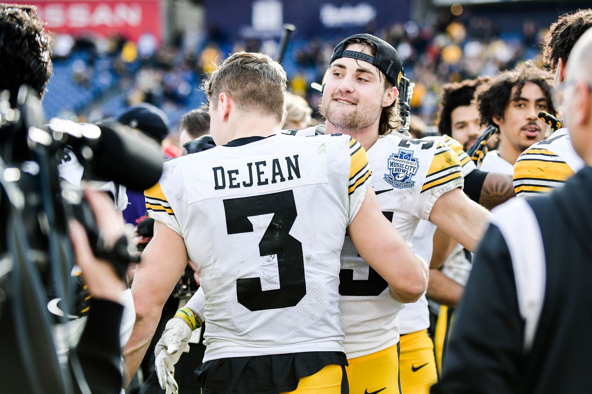 Cooper DeJean #3 and Riley Moss #33 of the Iowa Hawkeyes celebrate their win against the Kentucky Wildcats