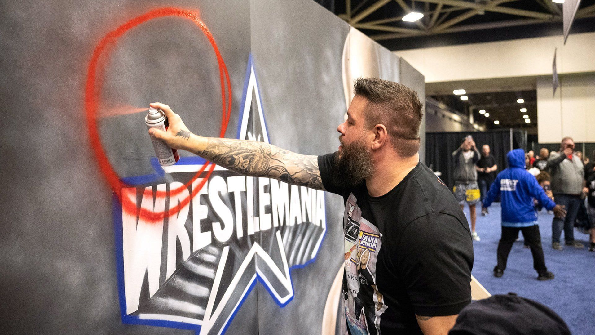 Kevin Owens spraypaints a WWE WrestleMania 38 sign to taunt Steve Austin