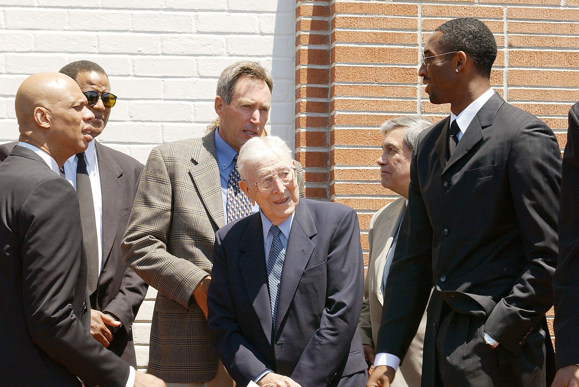 Kareem Abdul-Jabbar, John Wooden, and Kobe Bryant at a memorial.