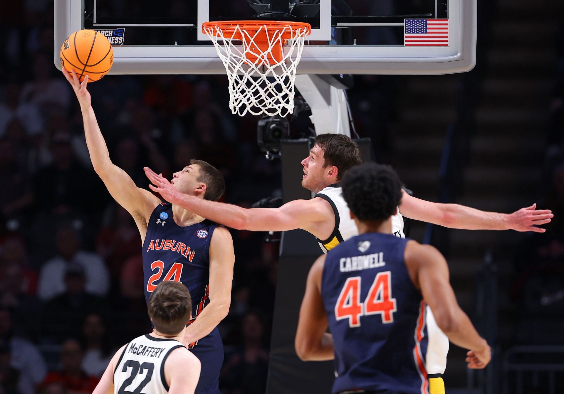 Lior Berman #24 of the Auburn Tigers scores against Filip Rebraca #0 of the Iowa Hawkeyes during the first half in the first round of the NCAA Men&#039;s Basketball Tournament