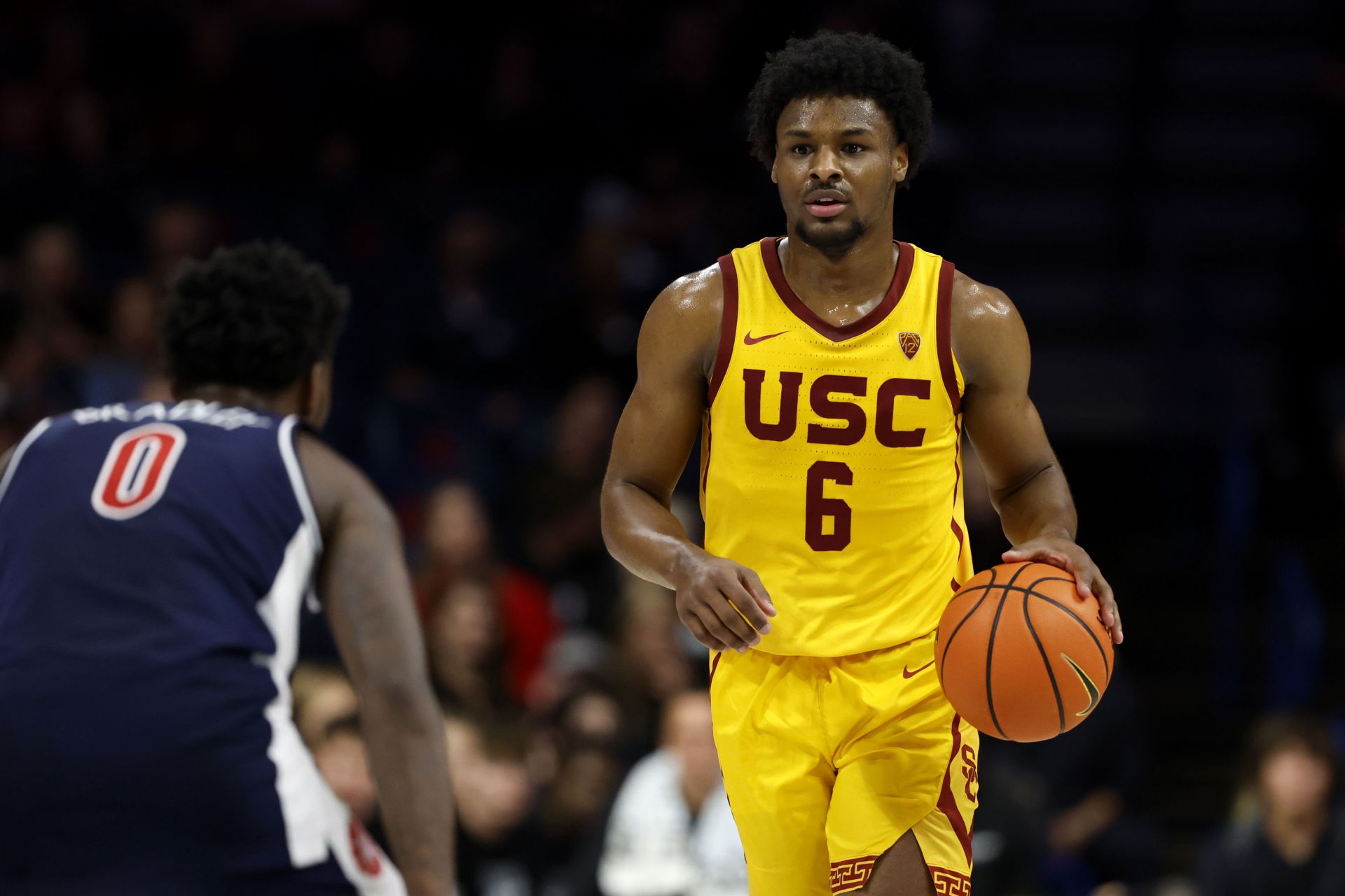 Bronny James #6 of the USC Trojans controls the ball against Jaden Bradley #0 of the Arizona Wildcats during the second half at McKale Center.