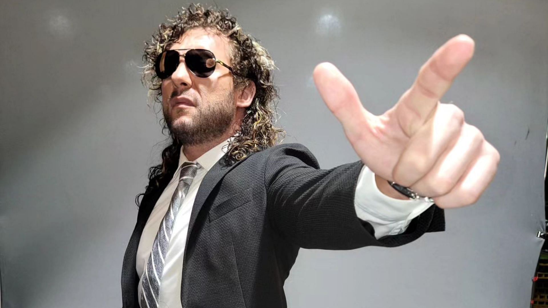 Kenny Omega poses backstage for AEW photo shoot