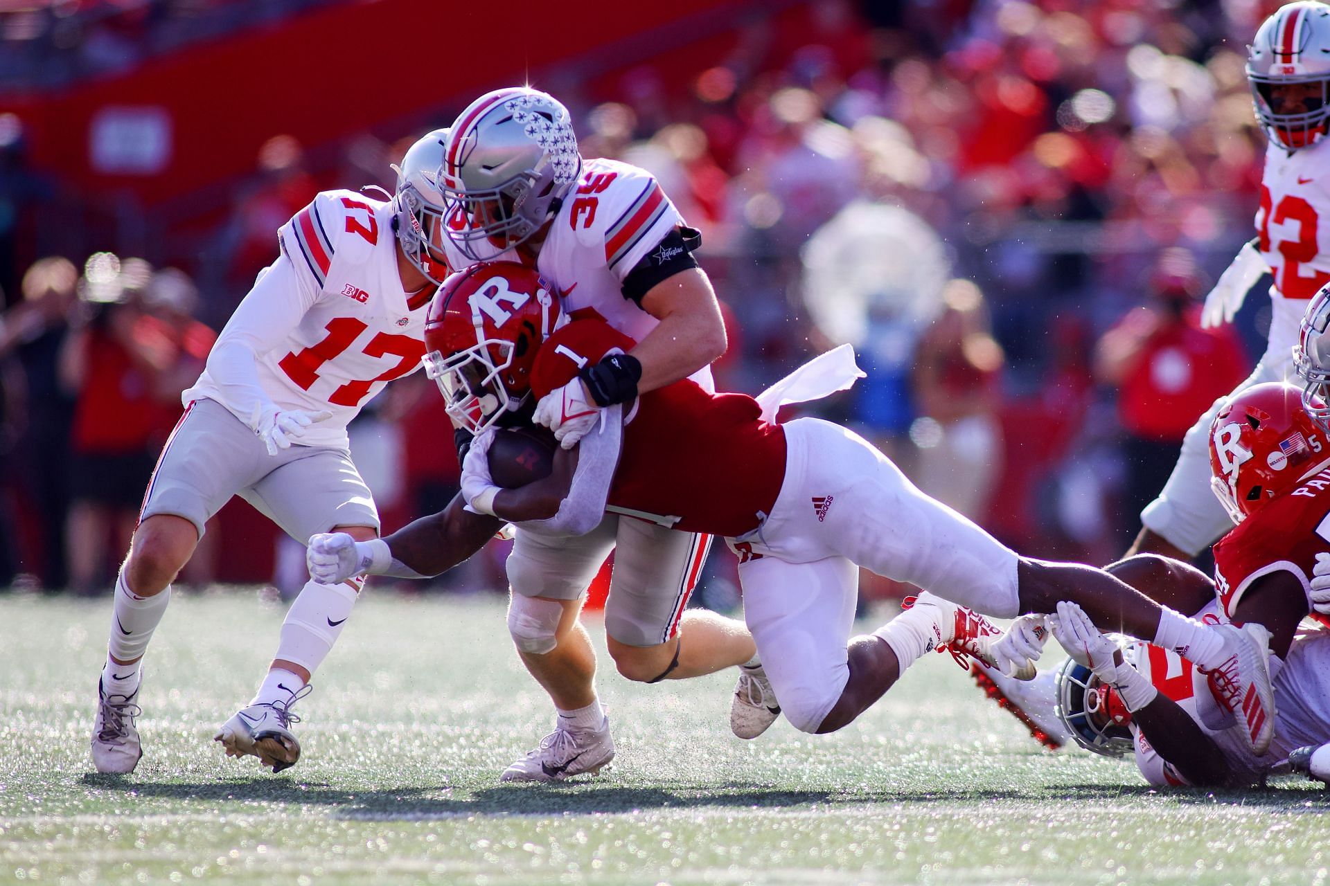 Demario McCall #1 of the Ohio State Buckeyes is tackled by Tommy Eichenberg #35 of the Ohio State Buckeyes