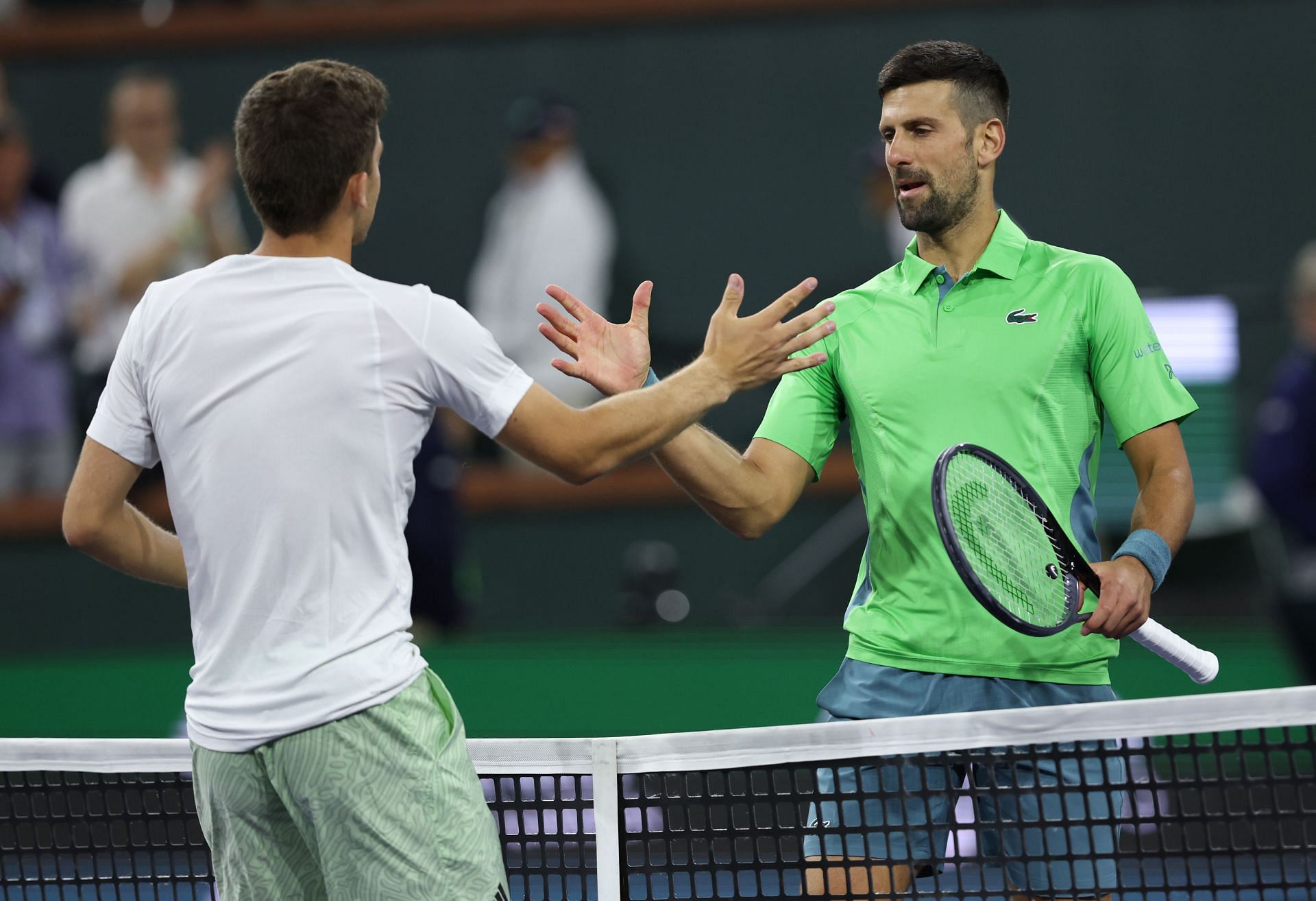 Luca Nardi (L) and Novak Djokovic (R) at the 2024 Indian Wells Masters