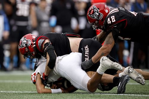 Payton Wilson #11 of the North Carolina State Wolfpack sacks Taulia Tagovailoa #3 of the Maryland Terrapins