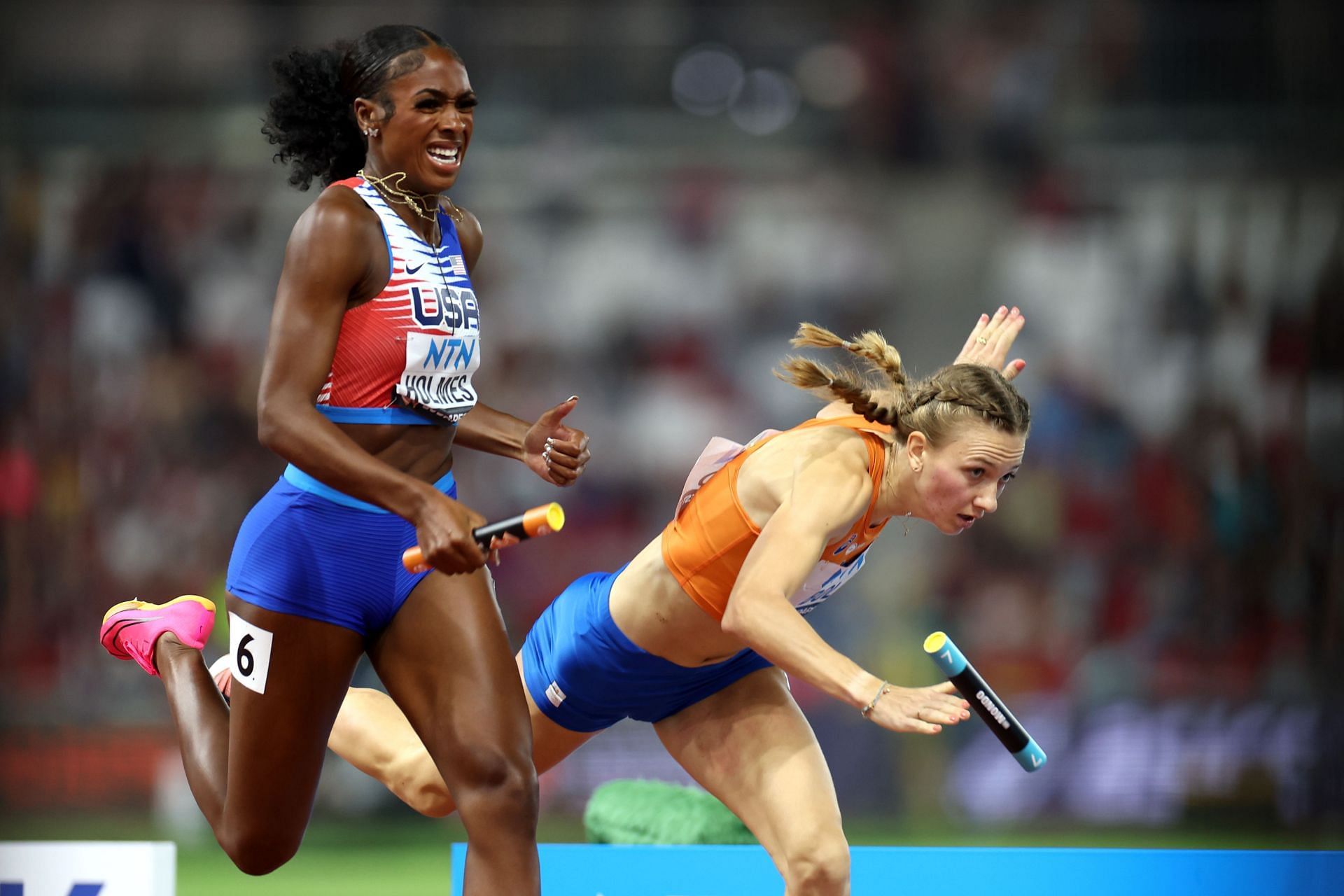 Alexis Holmes of Team United States crosses the finish line to win the 4x400m Mixed Relay Final as Femke Bol of Team Netherlands falls during day one of the World Athletics Championships Budapest 2023 at the National Athletics Centre in Budapest, Hungary.