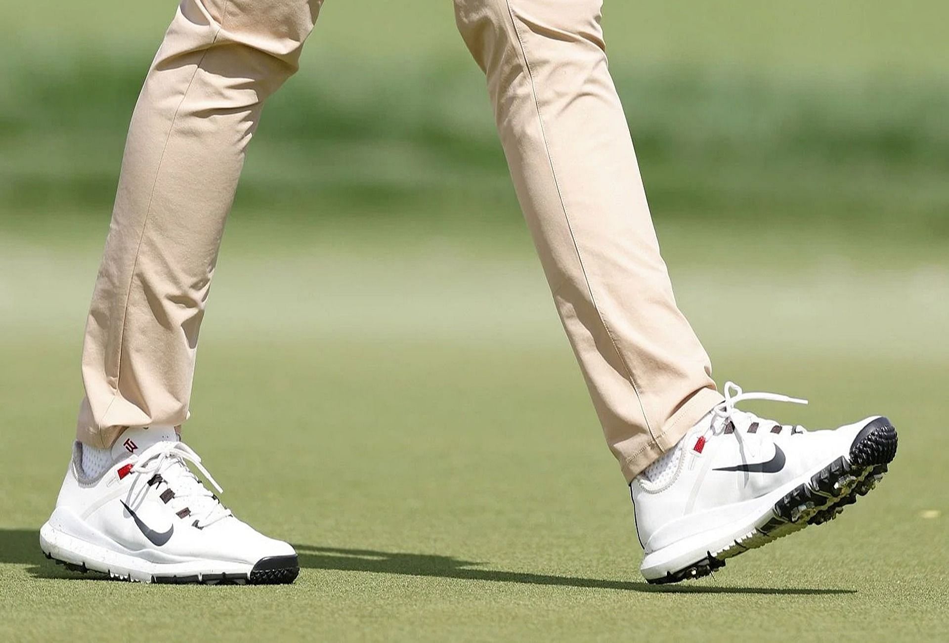 Tommy Fleetwood wears the Tiger 13 shoes with Tiger Woods